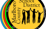 Marlboro County School District logo with silhouettes of four people holding hands and town names circling the border.