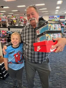 Man, child, and shoe boxes