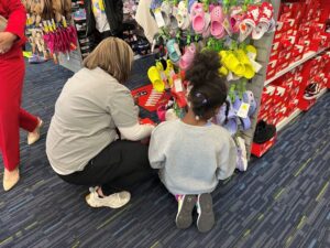 Child and Rotary member in store