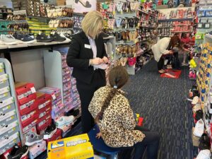 Child and Rotary member in store