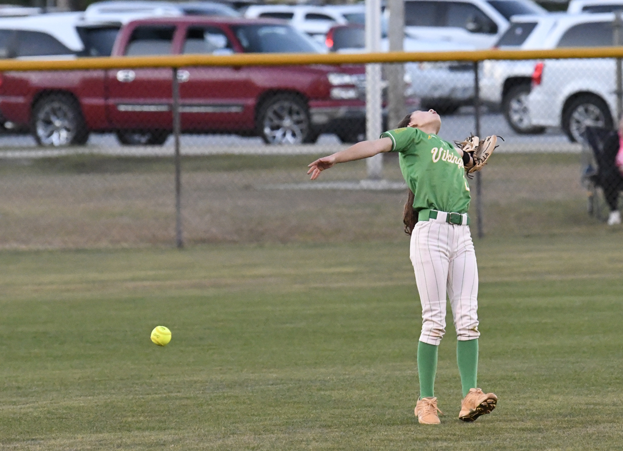  the softball is just over the head of the centerfielder