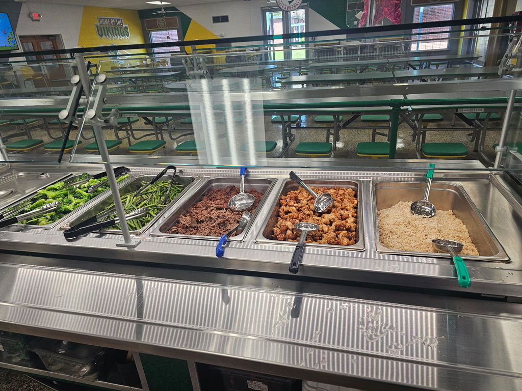 A food serving station that shows various items including asparagus