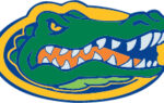 Stylized alligator head logo with fierce eyes and sharp teeth, outlined in yellow, blue, and orange colors.