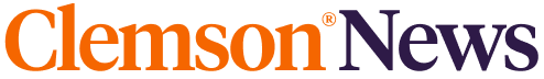 Partial logo text in orange and dark purple letters on a transparent background.