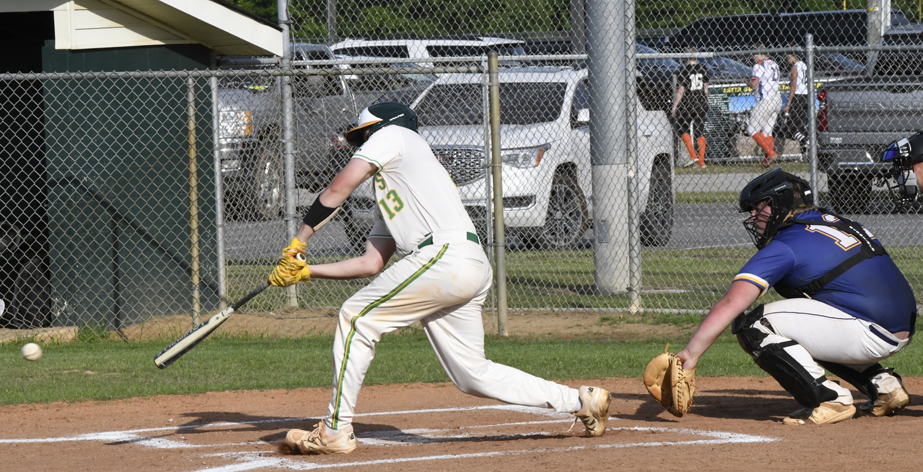 A baseball player in white swings a bat at a pitched ball, while a catcher in blue gear crouches behind home plate during a game.
