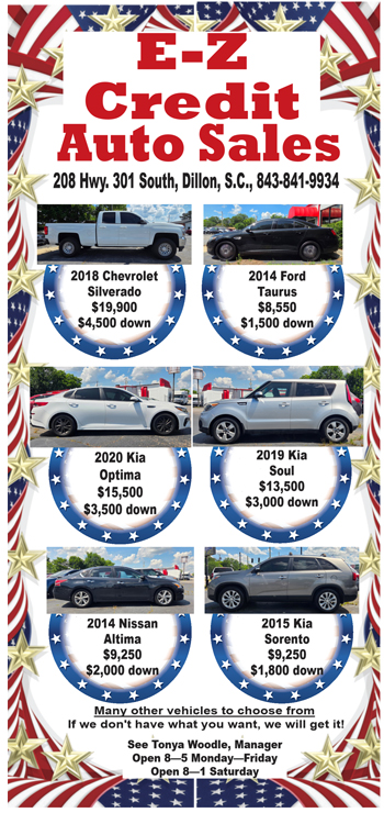 E-Z Credit Auto Sales flyer displaying cars for sale with prices, down payments, dealership address, phone number, American flag and star border, and manager’s message.
