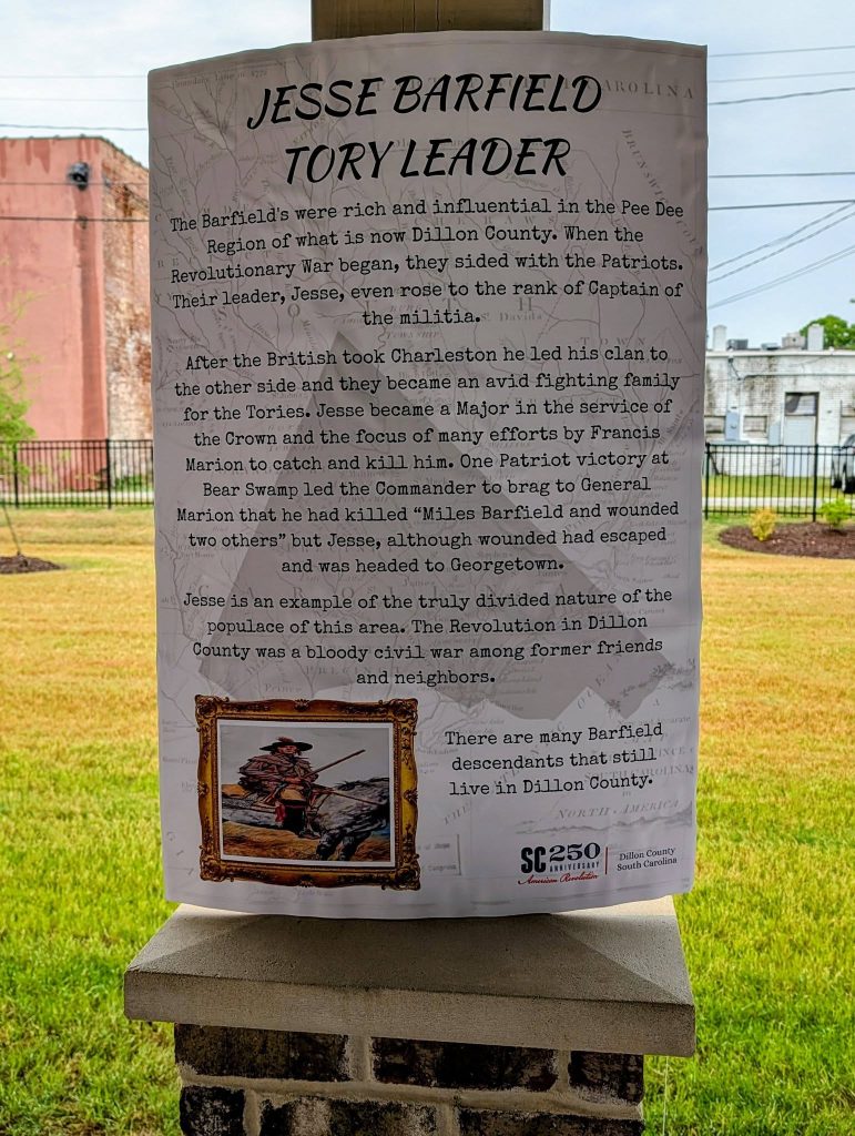 Historical sign about Jesse Barfield, Tory leader during the Revolutionary War, with text describing his actions and legacy, and a framed illustration of a soldier.