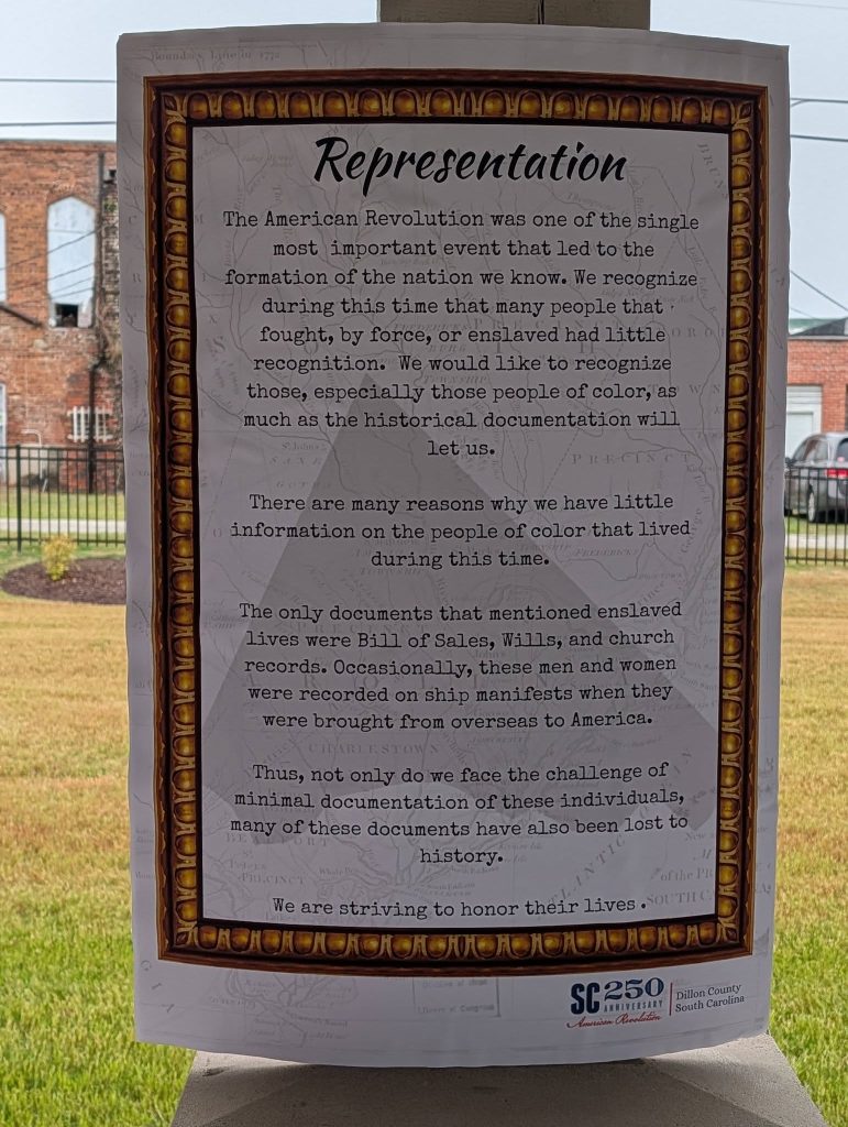Poster about representation of enslaved people during the American Revolution, discussing minimal documentation and efforts to honor their lives; located in Dillon County, South Carolina.