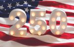 Large illuminated numbers "250" on a wavy American flag background, celebrating the 250th anniversary of the United States.