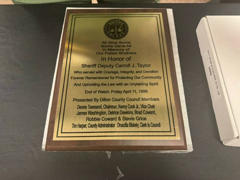 Commemorative plaque honoring Sheriff Deputy Carroll J. Taylor for courageous service, presented by Dillon County Council members, with an inscribed dedication and list of presenters.