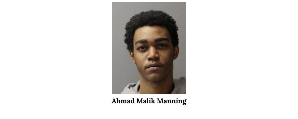 A young man with short curly hair, wearing a light-colored hoodie, photographed against a gray background, with the name "Ahmad Malik Manning" written below.