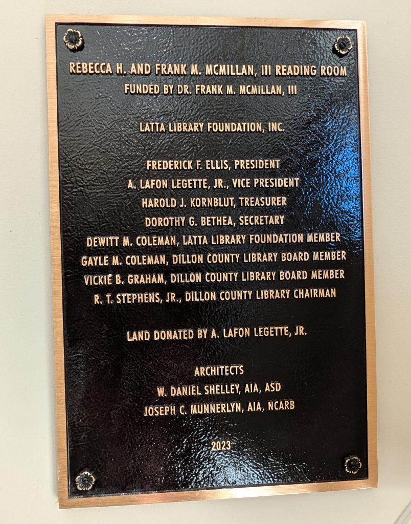 Plaque for the Rebecca H. and Frank M. McMillan, III Reading Room, listing donors, Latta Library Foundation members, architects, and land donor. Dated 2023.