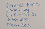 Whiteboard with handwritten voting information: runoff June 23, early voting June 17-18, general election Nov. 3, early voting Oct. 19-31, 8:30-6:00, Monday-Saturday.