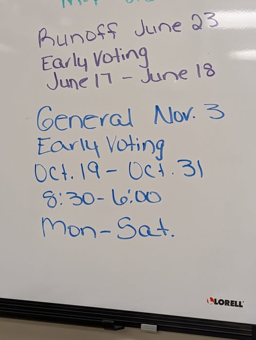 Whiteboard with handwritten voting information: runoff June 23, early voting June 17-18, general election Nov. 3, early voting Oct. 19-31, 8:30-6:00, Monday-Saturday.