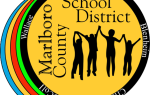 Marlboro County School District logo with silhouettes of people holding hands, surrounded by names: Bennettsville, Blenheim, Clio, McColl, and Wallace.